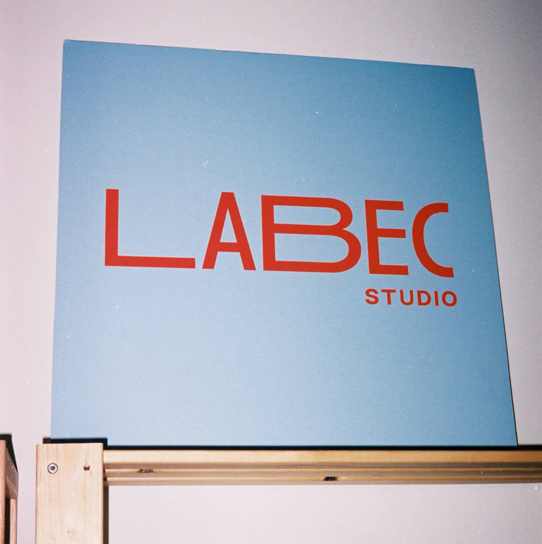 Labec Studio brand identity, logo on a blue backdrop.